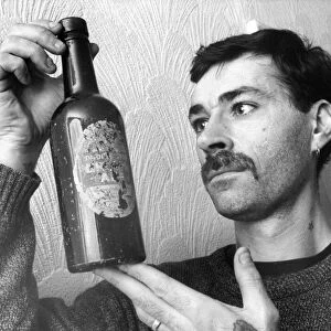 Edward Jelley with a Brown Ale bottle found in his allotment in Walker