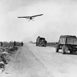 El Hamma road serves as impromptu airfield. A Stimson aircraft takes off from the road El Hamma road serves as impromptu airfield. A Stimson aircraft takes off from the road