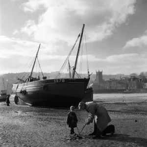 An elderly man at the harbour in the village of St Ives in Cornwall with a young boy An elderly man at the harbour in the village of St Ives in Cornwall with a young boy