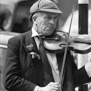 Elderly street musician performing on the streets of central London Elderly street musician performing on the streets of central London