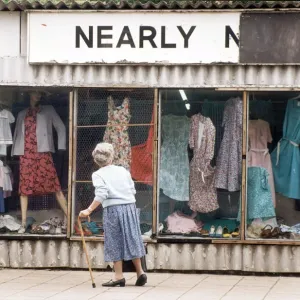 An elderly woman pauses to look at the World War Two prefab shop on the corner of An elderly woman pauses to look at the World War Two prefab shop on the corner of