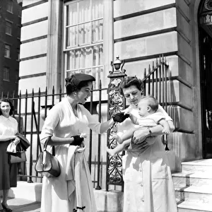Elizabeth Taylor hands over her baby to nurse while she and her husband tours Europe
