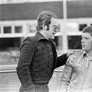 Elton John with a fan. 22nd December 1973