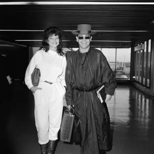 Elton John and Renate Blauel arriving at Heathrow Airport, Print 1984 Elton John and Renate Blauel arriving at Heathrow Airport, Print 1984
