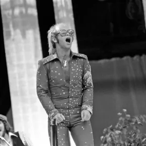 Elton John performing on stage at Wembley Stadium. London Elton John performing on stage at Wembley Stadium. London
