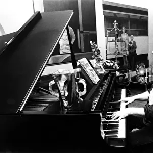 Elton John pictured seated at a piano. December 1978. Published in