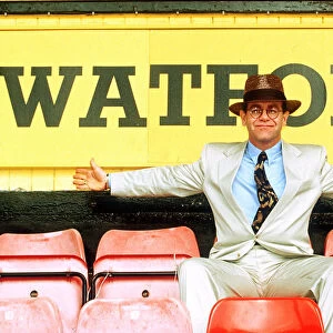 Elton John on rejoining Watford football club as director sitting in front of sign white