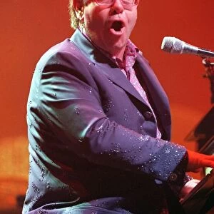 Elton John SECC concert Glasgow 11th December 1997 on stage playing piano wearing blue
