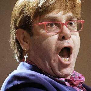 Elton John SECC concert Glasgow 11th December 1997 on stage playing piano wearing blue