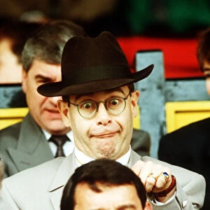 Elton John Singer & Chairman of Watford FC pulls a funny face at Manager Graham Taylor