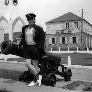 Elton John Singer Songwriter standing beside a cannon on the West Indies Island of Elton John Singer Songwriter standing beside a cannon on the West Indies Island of