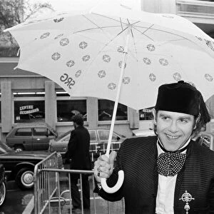 Elton John standing in the rain. He is in Montreux to perform at the Montreux Pop