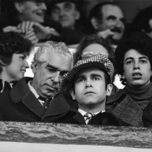 Elton John watching the West Ham United v Watford football match. 7th January 1978 Elton John watching the West Ham United v Watford football match. 7th January 1978