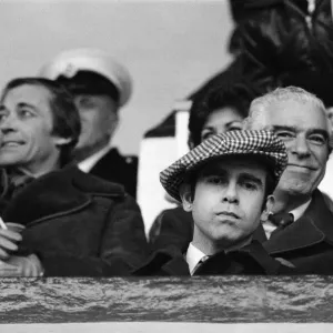 Elton John watching the West Ham United v Watford football match. 7th January 1978 Elton John watching the West Ham United v Watford football match. 7th January 1978