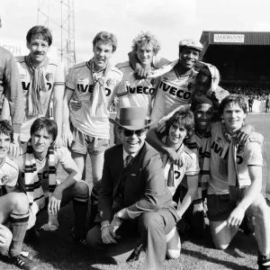 Elton John and the Watford side pose for the photographers after their match against Elton John and the Watford side pose for the photographers after their match against