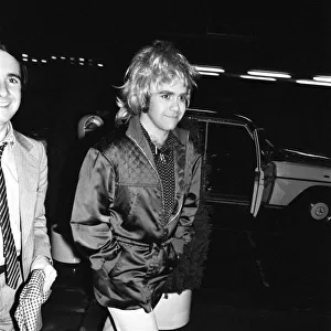 Elton John wearing a womans wig, seen arriving at a party to celebrate his London