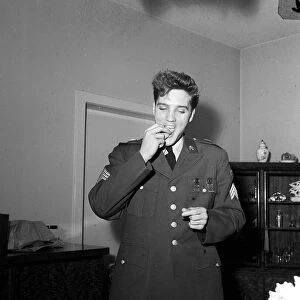 Elvis Presley eating before at press conference in Germany, March 1960