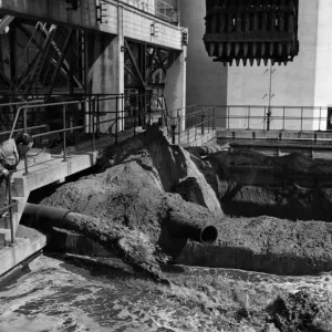 One of the employees at the Aberthaw power station watched the used ash mixed with water One of the employees at the Aberthaw power station watched the used ash mixed with water