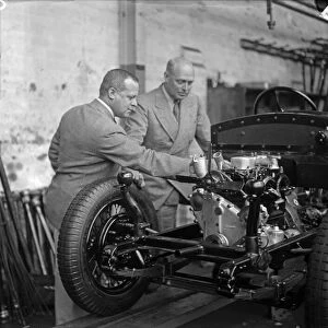 Engine mounted on the chassis of a car on the production line is inspected at the Triumph
