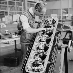 An engineer checks the pistons of the Gipsy Six engine during the construction of