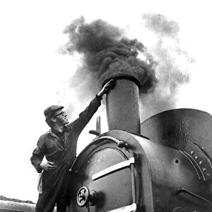 An Engineer giving his steam locomotive a last clean before going on show to the public