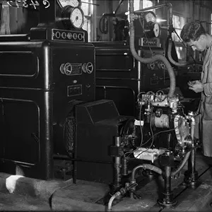 Engines being assembled at the Triumph car factory in Coventry. 23 September 1931