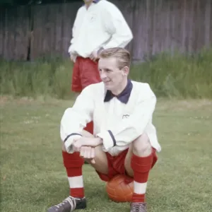 England football team training. George Eastham sitting down, watched by Roger Hunt England football team training. George Eastham sitting down, watched by Roger Hunt