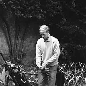 England footballer Bobby Charlton chosses his club as enjoys a round of golf during an
