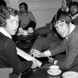 England Players: Emlyn Hughes and Alan Ball with a cricket bat that was autographed by