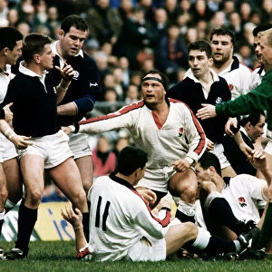 Englands Brian Moore lashes out at Craig Chalmers of Scotland as team mates try