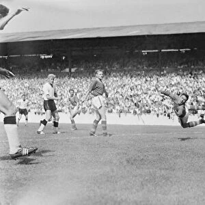 English League Division One match. Burgin the Leeds goalie turns in mid air to see