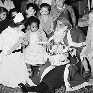 English musician Ray Ellington dressed as Santa Claus at the Paddington Green Hospital