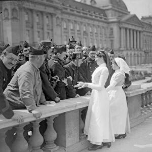 English nurses seen here meeting Belgian soldiers outside the Royal Palace before