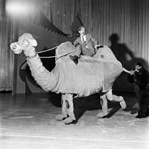 Entertainment: Sinbad on ice: Norman Wisdom seated on camel with George Knowlee playing
