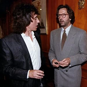 Eric Clapton at party chatting with Bill Wyman. 1995