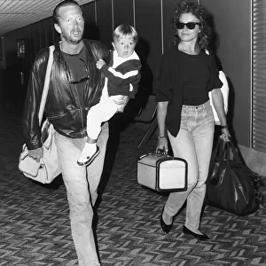 Eric Clapton singer songwriter and girlfriend Lori Del Santo walk through airport with