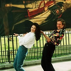 Eric Idle and Catherine Zeta Jones carrying painting 1993