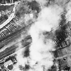 The Erla Aircraft factory in Antwerp burning after a U. S. A. A. F