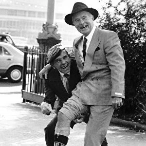 Ernie Wise with Noman Wisdom showing off his legs at the International Men