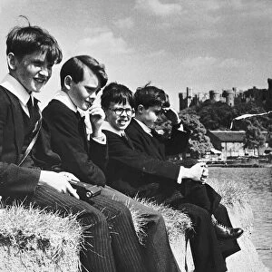 Eton pupils sitting on the edge of a river bank Dbase MSI