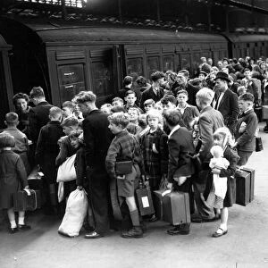 Evacuation scenes at Euston Station, London, boarding a train to Lancashire. July 1944