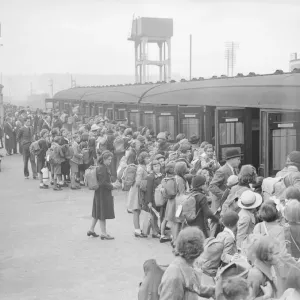 Print of children boarding a train for evacuation during World War II Print of children boarding a train for evacuation during World War II