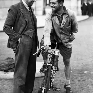 Everton footballer Dixie Dean talking with a cyclist in Liverpool. Circa 1936