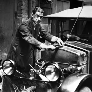 Everton footballer William Dixie'Dean dressed in mechanic overalls as he goes