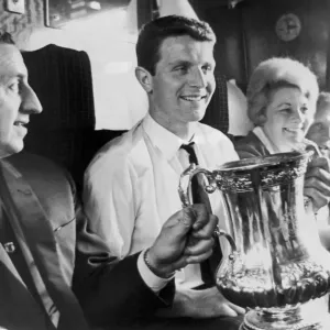 Everton manager Harry Catterick holds the FA Cup trophy on the train journey back to Everton manager Harry Catterick holds the FA Cup trophy on the train journey back to