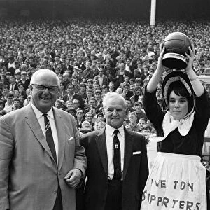 Everton toffee lady, 16 year old Catherine Dunn, holds a trophy presented to Everton