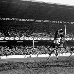 Everton v. Arsenal: West punches away corner kick from McLintockIs head with Hurst