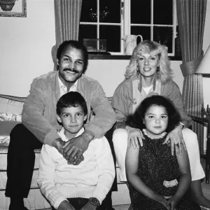 Black and white print of John Conteh at home with family