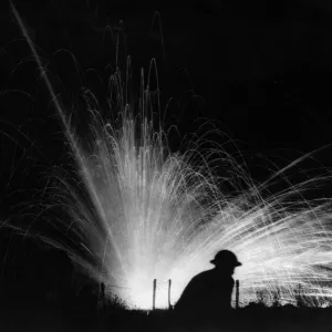 An exploding phosphorous round silhouettes a helmeted American soldier of the 28th An exploding phosphorous round silhouettes a helmeted American soldier of the 28th