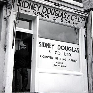 An exterior view of Sidney Douglas betting shop in Mile End Road London May 1961